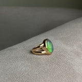 Black and green opal bezel set in solid 14k yellow gold statement ring with split shank. 