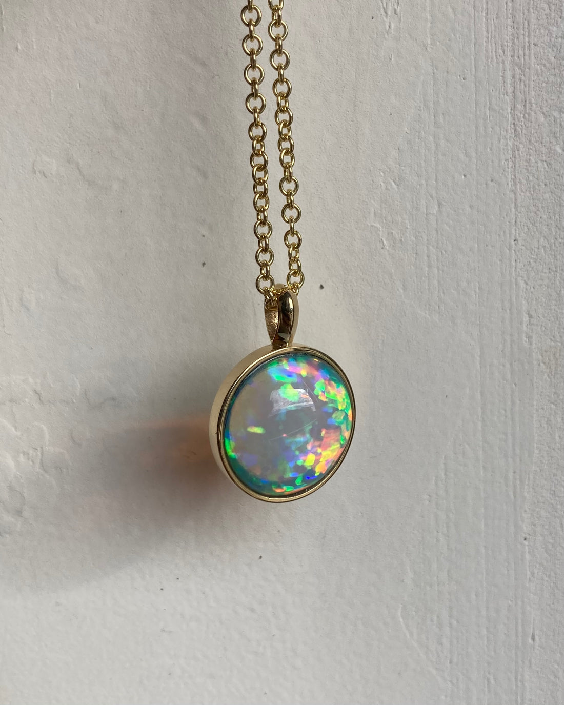 Solid 14k yellow gold necklace with Rainbow play of fire crystal opal in bezel setting